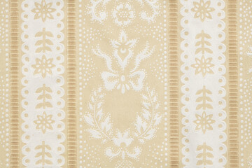 Old wallpaper on the wall. Old wallpaper for texture or background.