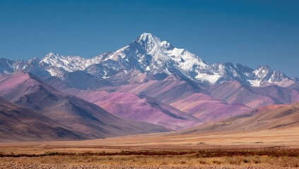 Mountain range with snow-capped peak and colorful foothills