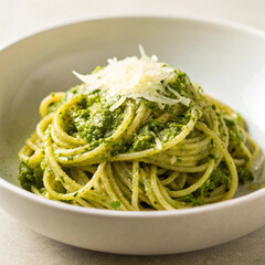 Realistic photo of spaghetti with basil pesto sauce, parmesan, and pine nuts