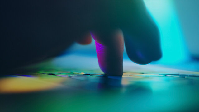 Finger touching interactive surface with colorful lighting effects