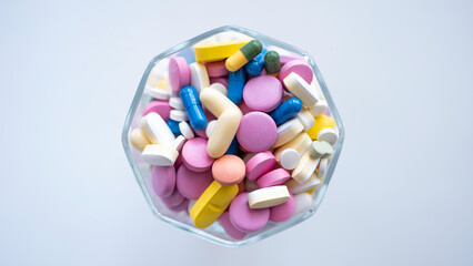 Pills, tablets, capsules, vitamins and omega3 in the glass