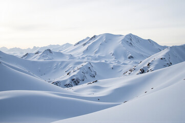 A breathtaking view of snow-covered mountains under a clear sky.