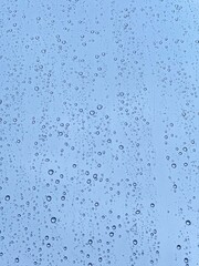 Rain-covered glass as a visual metaphor for global water scarcity and the urgent need for conservation and sustainable practices