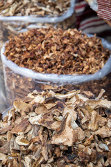 Dried porcini mushrooms and chanterelles close-up. Sale of dried mushrooms at the market in bulk in a bag. Full frame. View from above. Cooking. Vegetarianism. Preparation for the winter.
