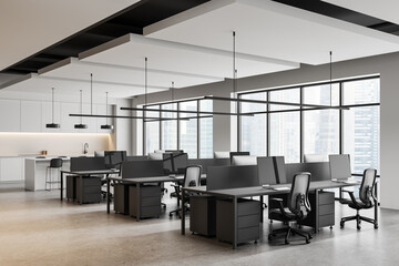 Modern open space office interior with workstations and ergonomic chairs in a high-rise building,...