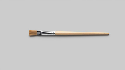 Simple Flat Head Paintbrush with Wooden Handle and Metal Ferrule on a Solid Gray Background