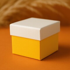 Fototapeta premium Bright yellow gift box with a white lid on an orange background