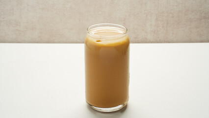 Iced coffee latte on white background/ Pouring Coffee into Iced Milk Drink/Pouring Espresso into Iced Coffee Drink
