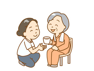 入浴後の高齢者にお茶を出す介護士