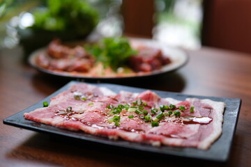 Grilled beef slices Chef slicing freshly grilled juicy beef steak meat with a knife on a wooden cutting board in the kitchen, food close-up zoom in