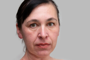Portrait of a woman close -up with wrinkles and age -related facial changes after forty years