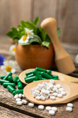 Alternative medicine herbal capsule organic drug on wooden background.Assortment of herbal and tablets,vitamins and dietary supplements.medicinal and Healing herbs.natural supplements for healthy life