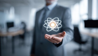 Businessman holds a projected atom graphic (1)
