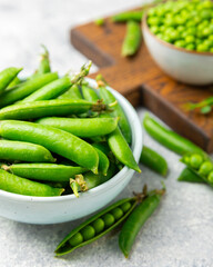 Fresh green pea pods with green peas on a wooden background. Sweet green peas. Green pea beans vegetables. Vegan. healthy vegetable. Copy space