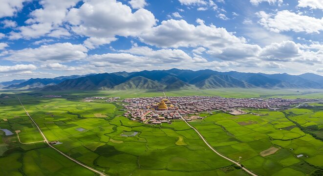An aerial panorama of Gannan Tibetan Autonomous Prefecture in Gansu Province, China with cloudy sky above