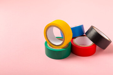 Insulating tape on a bright colored background. Set of different colors insulating tape. Reel...