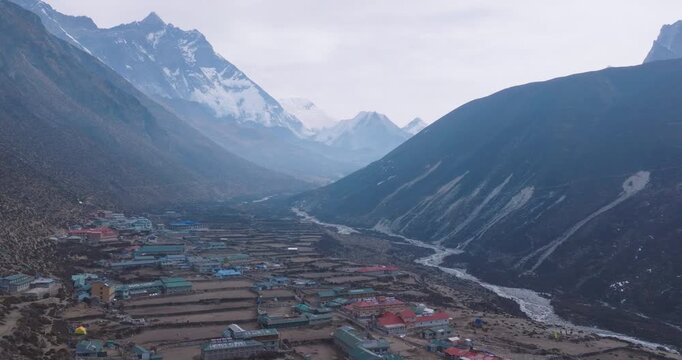 Drone view of Dingboche (4400m) with Sherpa village, rivers, dry lands, peak ranges, and hazy weather&mdash;diverse Himalayan lifestyle Tourism and travel Nepal, Nature conservation