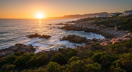 Beautiful capture of a beautiful sunset over a rocky coast, with waves crashing against the shore. hermanus, western cape.
