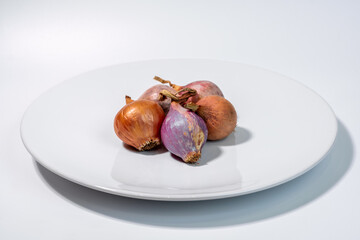 Whole fresh shallot onion isolated on a clean white background for cooking and agriculture concept