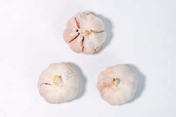 Close-up of a fresh garlic bulb isolated on a clean white background for culinary and health concept