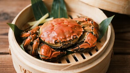 Yangcheng Lake hairy crabs, with vibrant shells tinged with orange and dark brown, strong claws, and slightly damp, shiny shells, are displayed in traditional bamboo steamers.