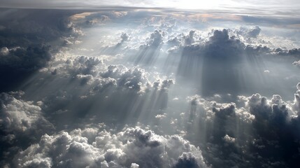 Fototapeta premium Sunbeams piercing a thick layer of clouds.