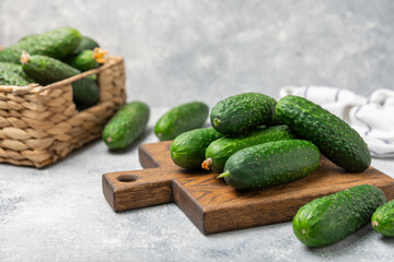 Cucumber on wooden background. Slice of cucumber on background. Fresh organic green cucumbers gherkin. Vegan. Salad ingredient. Farm vegetables. Cut vegetables with knife. Space for text. Copy space