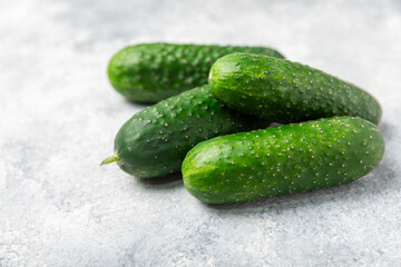 Cucumber on wooden background. Slice of cucumber on background. Fresh organic green cucumbers gherkin. Vegan. Salad ingredient. Farm vegetables. Cut vegetables with knife. Space for text. Copy space