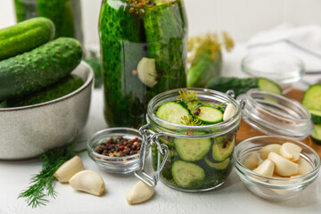 Freshly-salted homemade cucumbers in a jar on a wooden background. pickled cucumbers with dill,garlic and pepper.canned cucumbers.cucumbers and dill.Recipe of homemade preservations.fermented veggies.