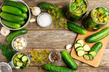 Freshly-salted homemade cucumbers in a jar on a wooden background. pickled cucumbers with dill,garlic and pepper.canned cucumbers.cucumbers and dill.Recipe of homemade preservations.fermented veggies.