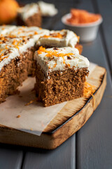 Homemade carrot cake on cutting board.