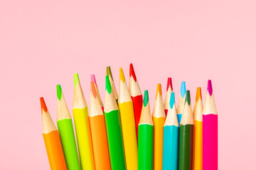 Colored pencils on a bright colored background. Equipment for coloring. Stationery for creativity.Back to school. Flatlay. Children's Creativity and Education. Rainbow.Space for text. Copy space.