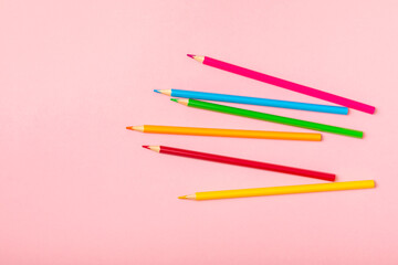 Colored pencils on a bright colored background. Equipment for coloring. Stationery for creativity.Back to school. Flatlay. Children's Creativity and Education. Rainbow.Space for text. Copy space.