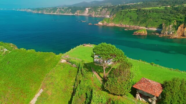 Aerial view of a Ermita de la Regalina on the steep cliffs in Asturias, Spain