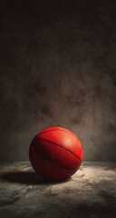 Red basketball on a textured surface, dark background