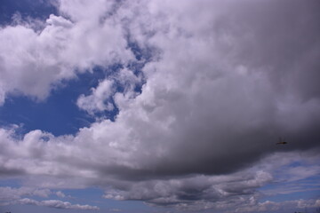 A beautiful blue sky filled with fluffy white cumulus and wispy cirrus clouds on a bright sunny day.