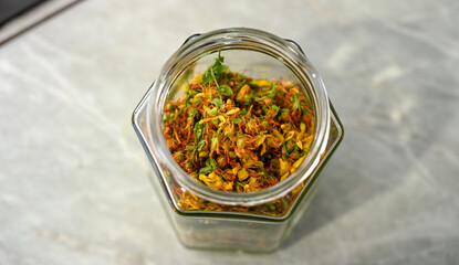 A jar full of dried St. John's wort. Tea in a jar.