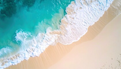 Aerial beach view with turquoise waves, light sand, and foamy surf in motion
