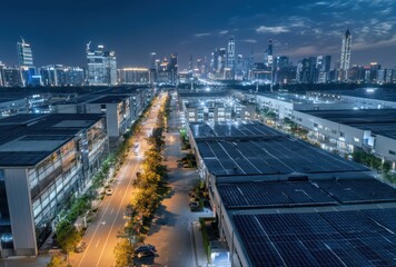 Aerial view of a modern urban landscape showcasing illuminated buildings, roadways, and a distant city skyline under a twilight sky.