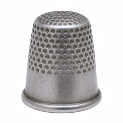 Close-up of a textured metal thimble, a sewing tool designed for protecting fingers during needlework and crafting.