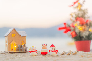 Santa Claus Doll Cute and Christmas Tree House Relaxing on the Beach. Merry Christmas Holiday. Bright Background. Patong Beach, Phuket, Thailand.