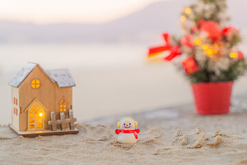 Santa Claus Doll Cute and Christmas Tree House Relaxing on the Beach. Merry Christmas Holiday. Bright Background. Patong Beach, Phuket, Thailand.