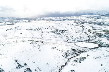 An epic drone photograph of the untouched beauty of a snowy wilderness exploration concept