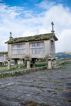 Stone buildings on pillars in a green field, smart ancient design.