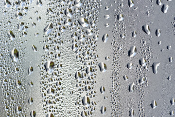 background, unusual, abstract. drops of morning dew, condensation on the glass. wet glass. water drops close-up. beautiful background for text. Spray cool condensate water on the glas