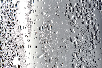 background, unusual, abstract. drops of morning dew, condensation on the glass. wet glass. water drops close-up. beautiful background for text. Spray cool condensate water on the glas