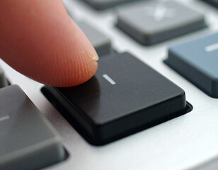 Finger Pressing Black Key on Keyboard, Close-Up View, Technology Concept