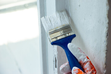 Photo of painting with white paint on wood. Interior painting. Making repairs, painting. White paint © Елена Загорий
