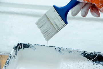 Photo of painting with white paint on wood. Interior painting. Making repairs, painting. White paint © Елена Загорий