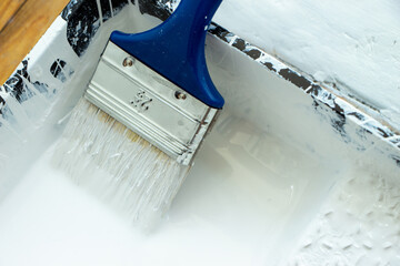 Photo of painting with white paint on wood. Interior painting. Making repairs, painting. White paint © Елена Загорий